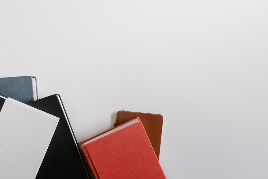 A collection of colorful hardcover notebooks arranged on a white background with copy space.