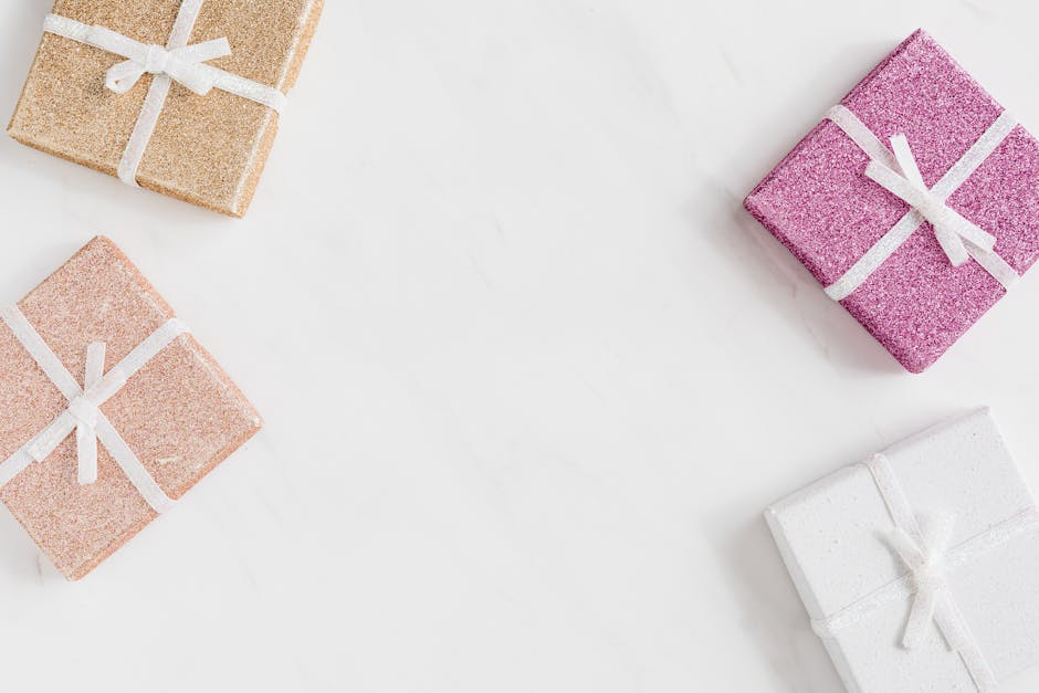 Glittery gift boxes on a white background with ample copy space, perfect for celebrations.
